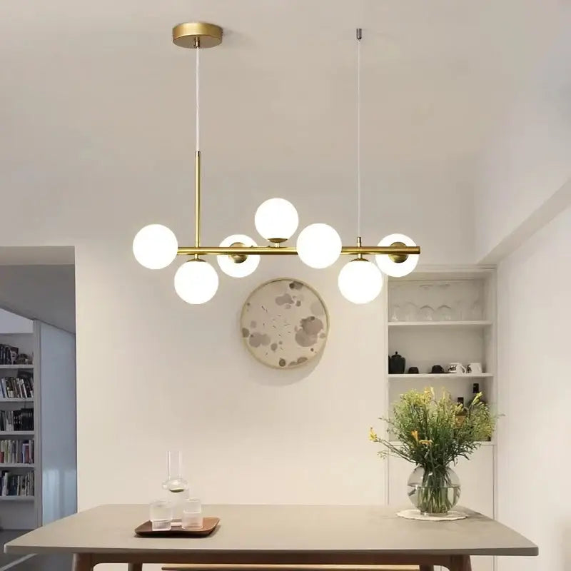 Modern brass DecorBites black gold Nordic pendant chandelier with multiple white glass bulbs for dining and living rooms
