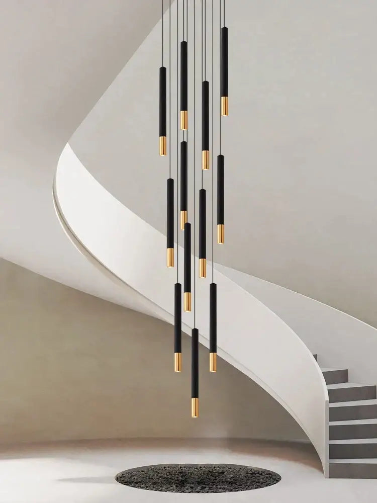 Decorbites black gold pendant lamp featuring black gold cylindrical LED lights in a modern minimalist indoor arrangement