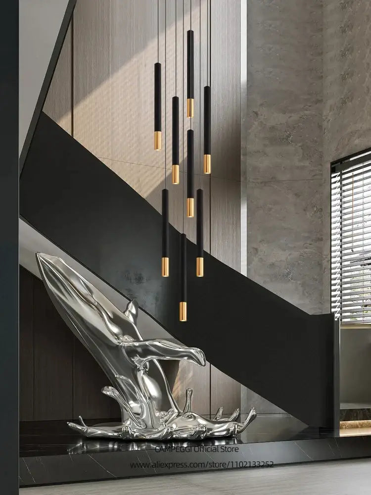 DecorBites black gold pendant lamp featuring a shiny silver metallic sculpture of a reclining abstract figure