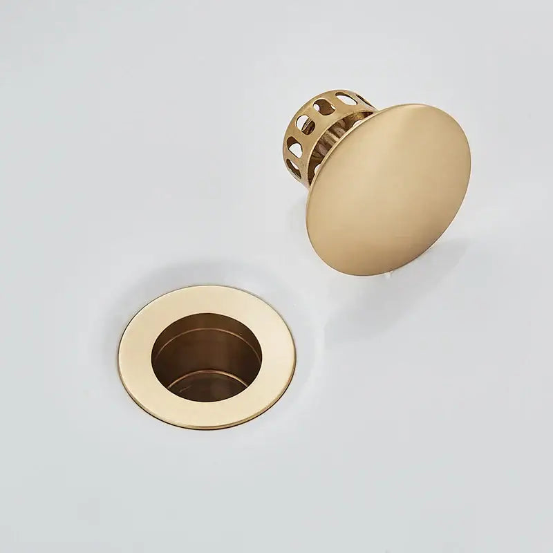 DecorBites black gold pop up drain with gold-toned round top and perforated mesh base in faucet accessory kit