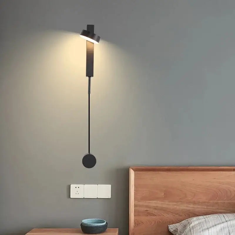 Modern decorbites black gold rotating wall lamp with adjustable head and circular base for bedroom and living room use