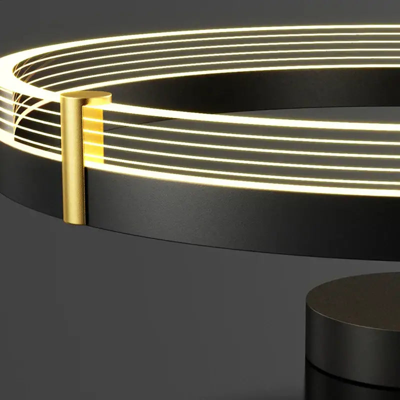 Modern black gold round chandelier by decorbites featuring a circular led light with sleek frame and warm gold accent bar