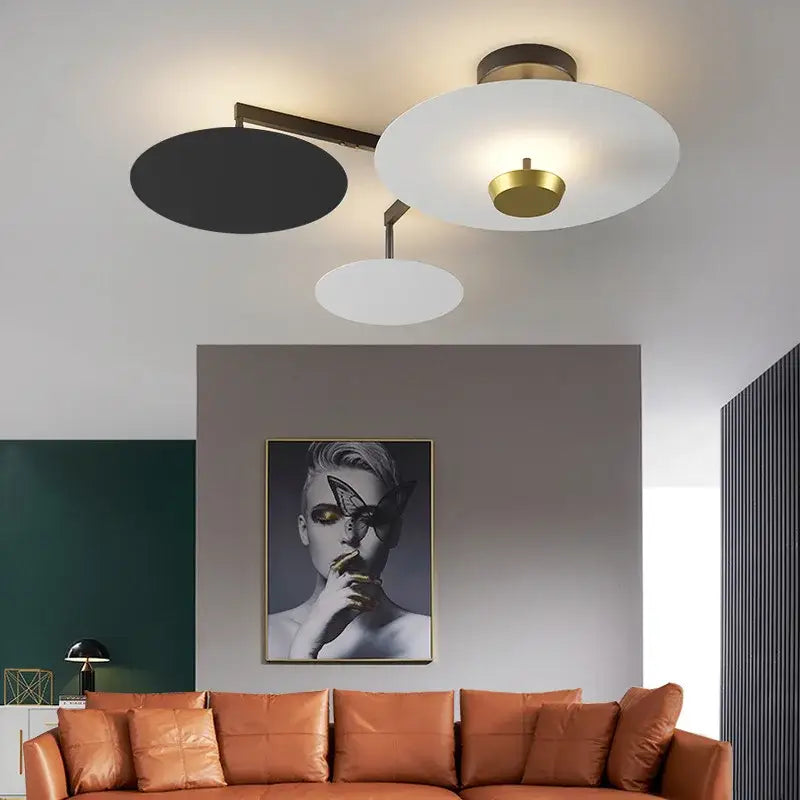 Modern decorbites black gold round chandelier with three circular shades in black white frosted glass and brass accents