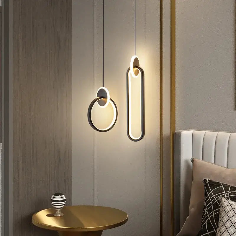 Modern minimalist pendant light with black gold round frame and warm glowing shapes for bedside decorbites black gold