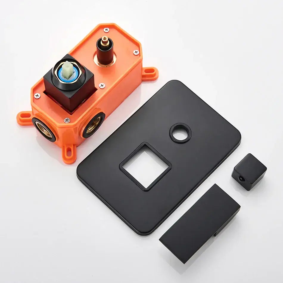 Orange plastic shower mixing valve assembly with black golden brass faceplate and concealed wall mount box control