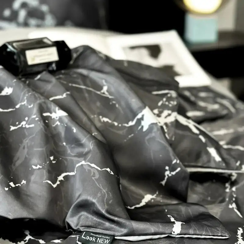 Black satin duvet cover set with white marble patterns made of ice silk for luxury cooling comfort and nordic style