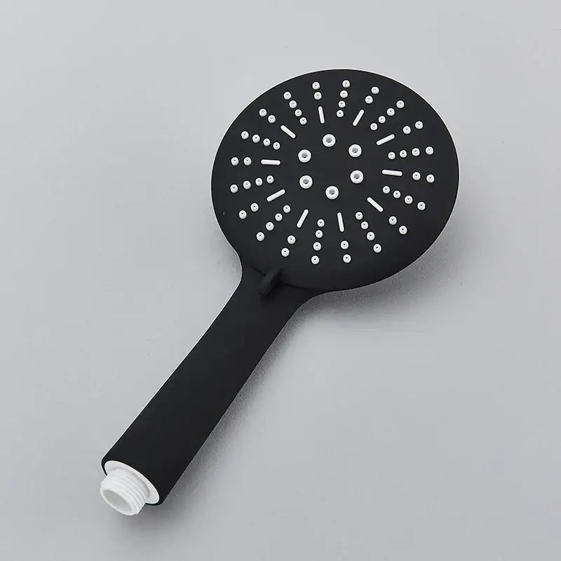 Black matte finish decorbites™ hand-held shower head with circular white nozzles for water saving rainfall use