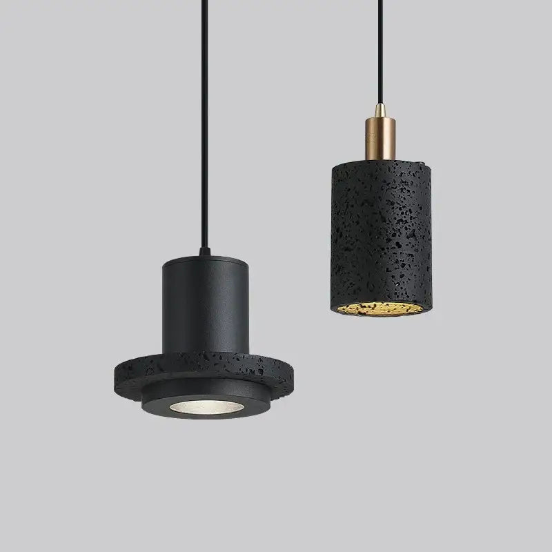 DecorBites black hole stone chandelier with black textured concrete pendant lights and gold accents for bedside decor