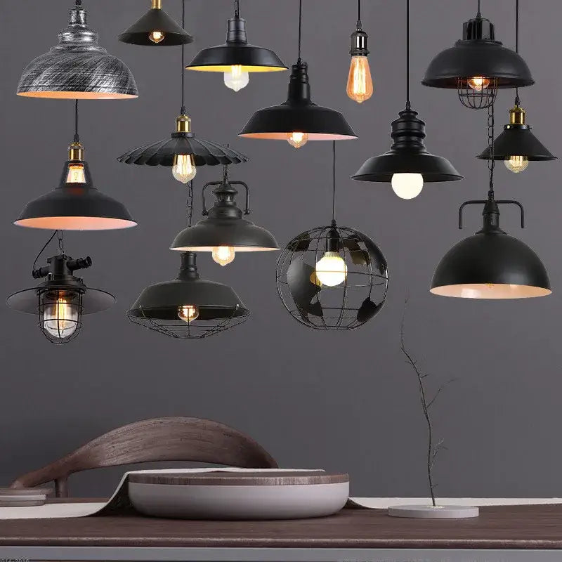 A collection of decorbites black industrial pendant lights featuring dome-shaped and wire cage shades for kitchen island decor