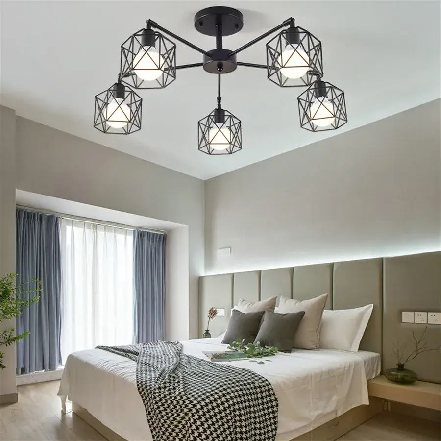 Decorbites black iron cage chandelier featuring five illuminated bulbs in an adjustable spider design ceiling lamp