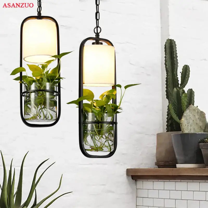 DecorBites black iron cage pendant light with frosted glass shade and integrated plant holders for loft decor