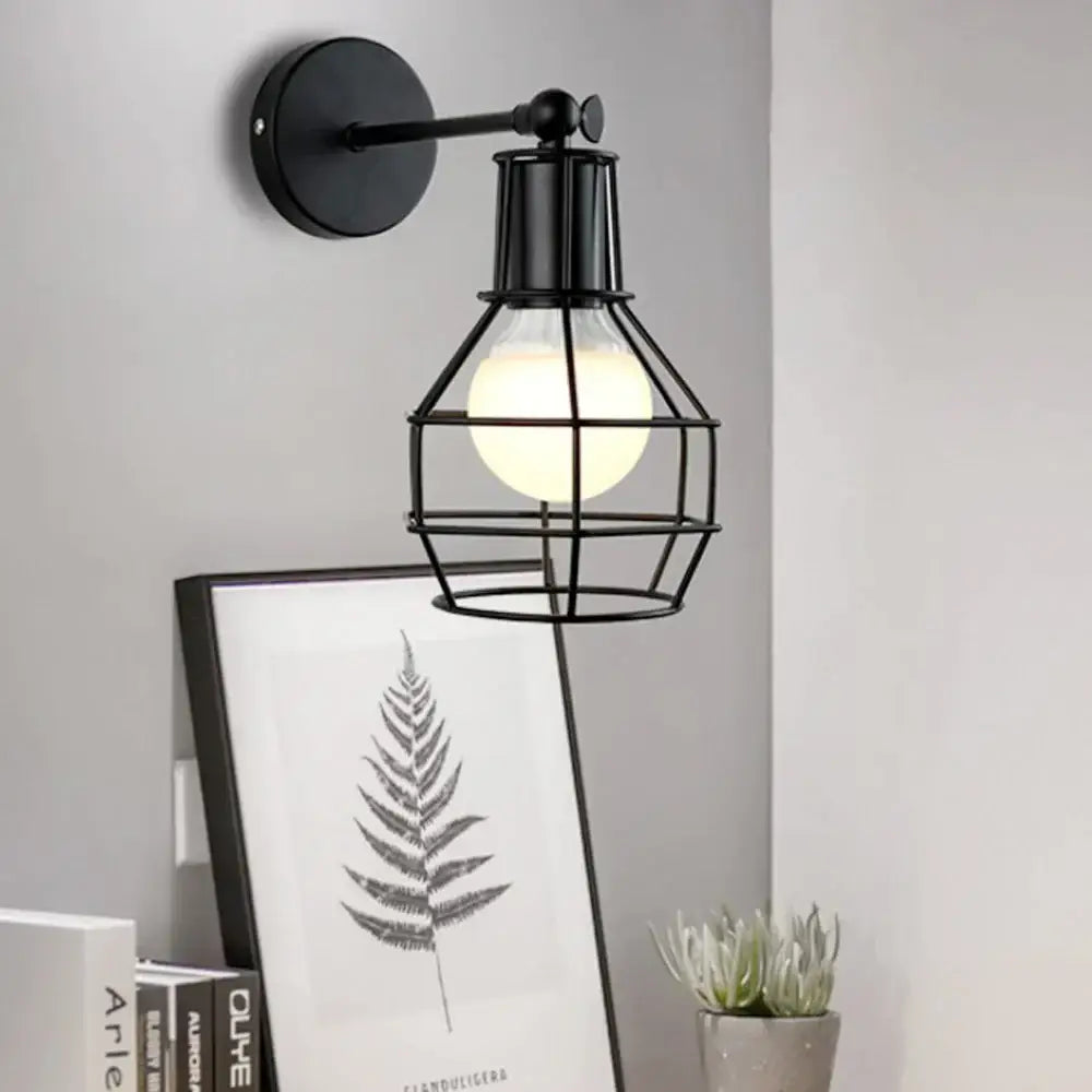 Decorbites black iron cage wall lamp with glowing bulb in a black metal cage retro indoor sconce for bedroom and bar