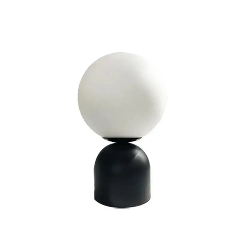 Minimalist DecorBites black iron table lamp with frosted white glass ball shade and sleek black cylindrical base for home decor