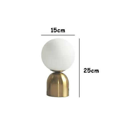A sleek decorbites black iron table lamp with a frosted glass ball shade and polished brass base for home decor