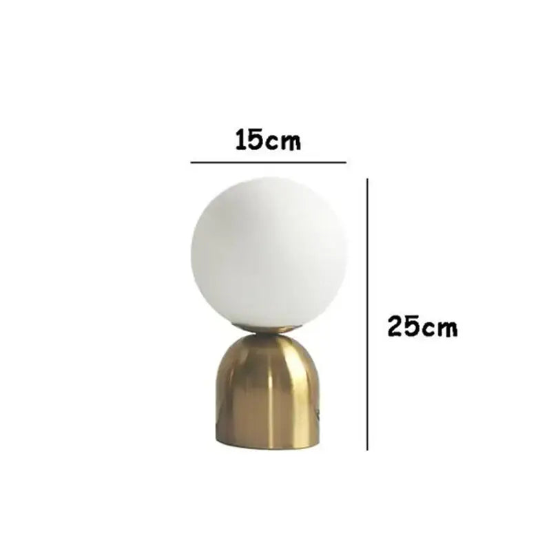 A sleek decorbites black iron table lamp with a frosted glass ball shade and polished brass base for home decor