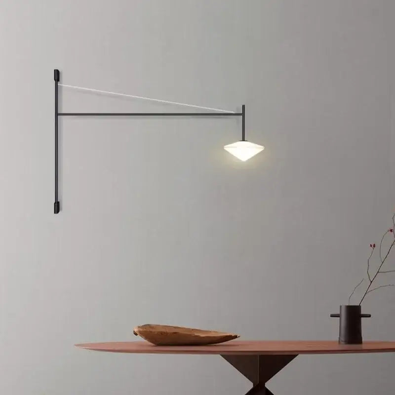 Black metal wall lamp with sleek angular design and glowing white triangular shade from decorbites black iron led long series
