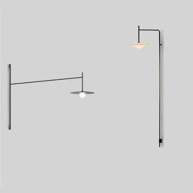 Two minimalist decorbites black iron led long wall lamps with slender arms and disc shades emitting warm light
