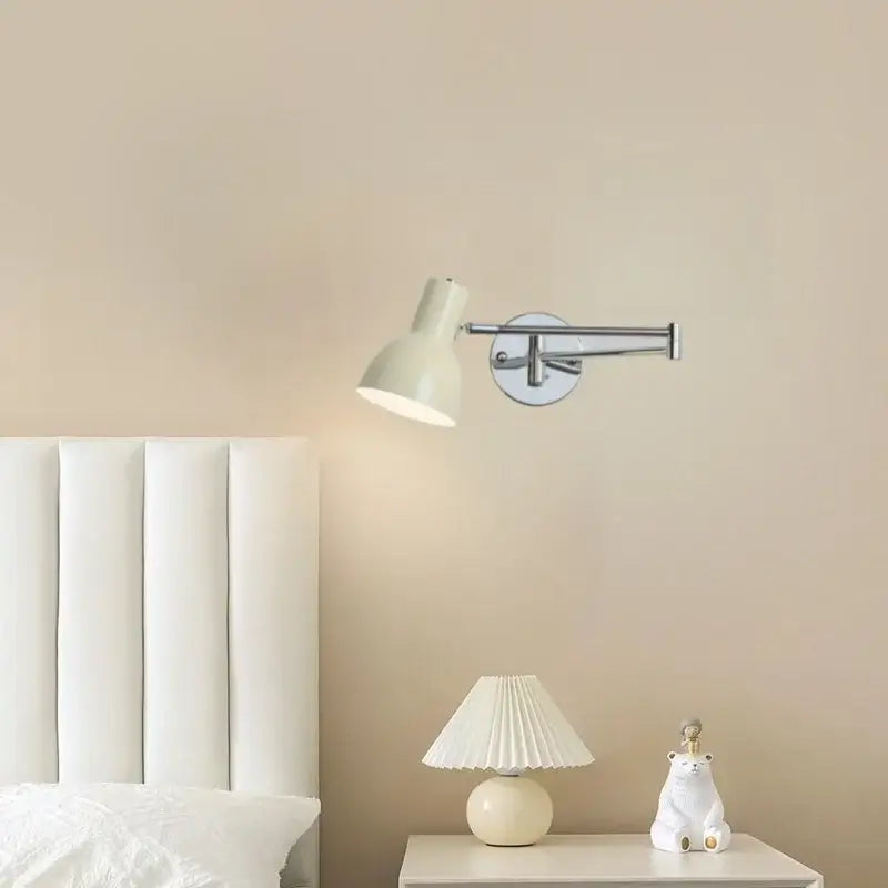 Cream-colored adjustable wall sconce with sleek chrome arm and circular base for decorbites black iron led modern nordic style