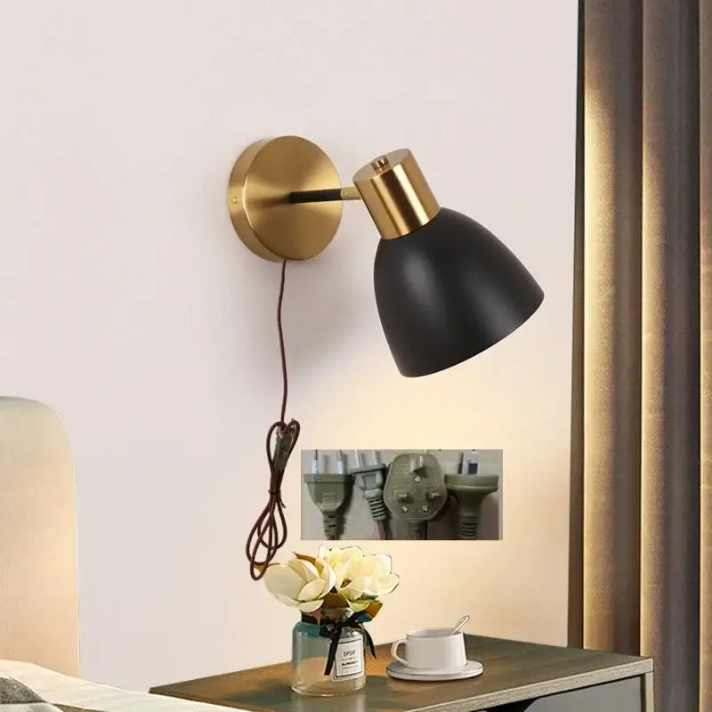 Decorbites black iron wall sconce with black matte finish gold-toned base and adjustable arm for modern lighting