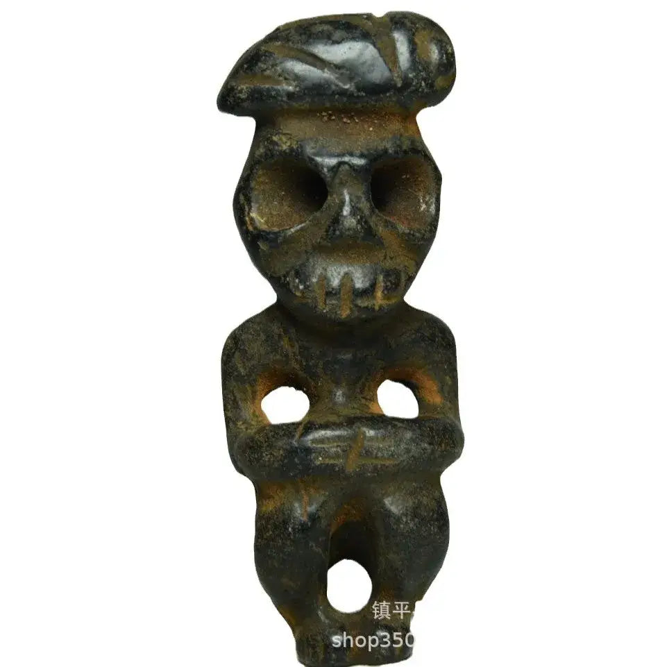 Dark weathered stone figurine with skull face and beret headwear decorbites black iron meteorite sun god statue