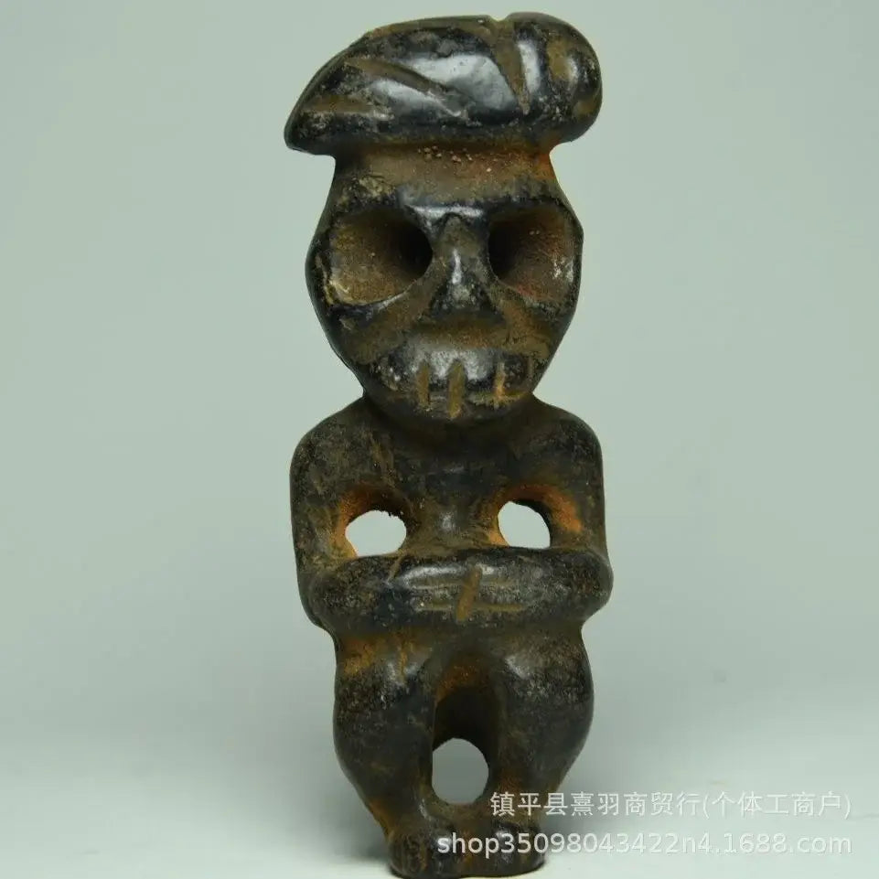 Dark weathered ceramic figurine with skull-like face and beret-style headwear from decorbites black iron meteorite sun statue
