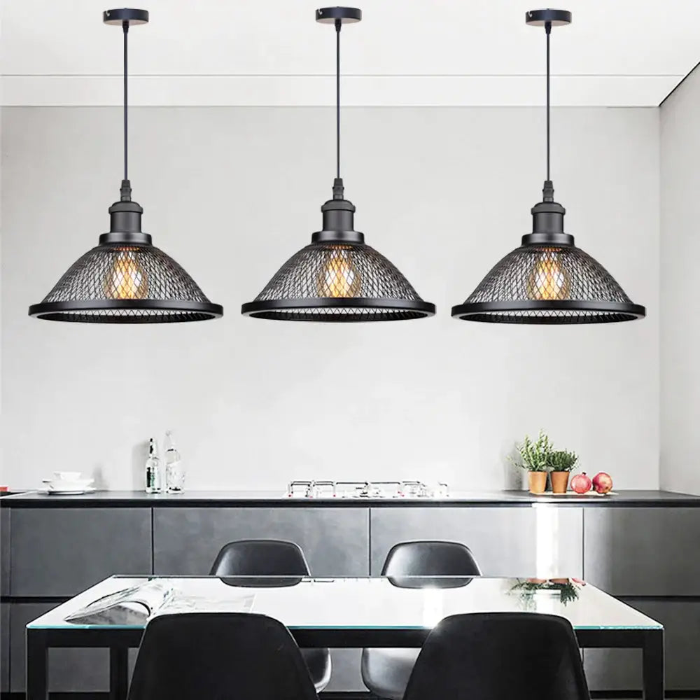 Three black iron mesh net-cage pendant light fixtures hang above a dining table for kitchen or living room use