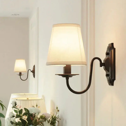 Antique bronze-finished decorbites black iron wall lamp with cream fabric shade for living room and bedroom lighting