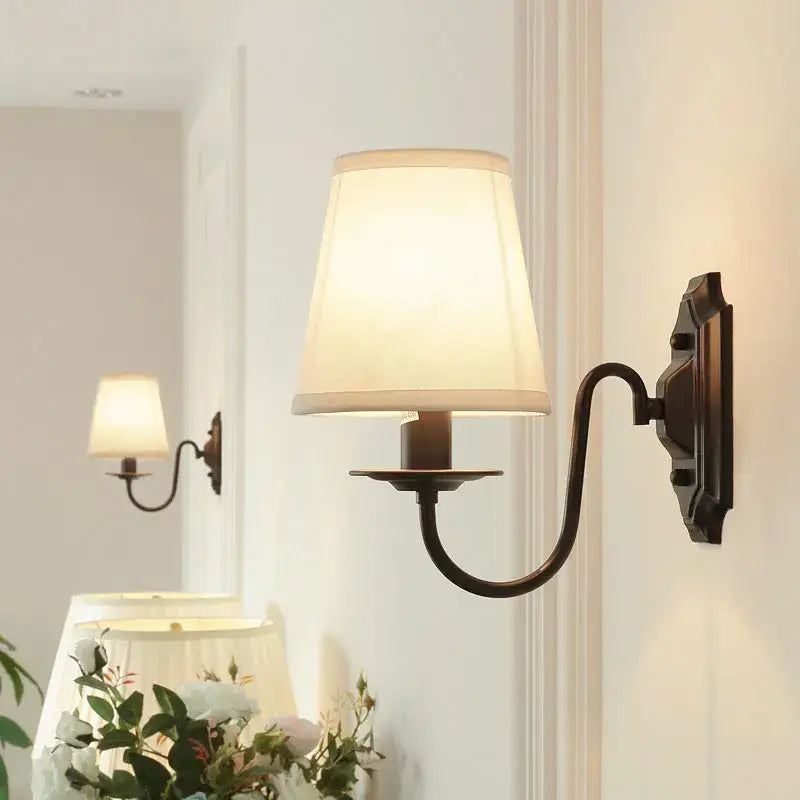 Antique bronze-finished decorbites black iron wall lamp with cream fabric shade for living room and bedroom lighting