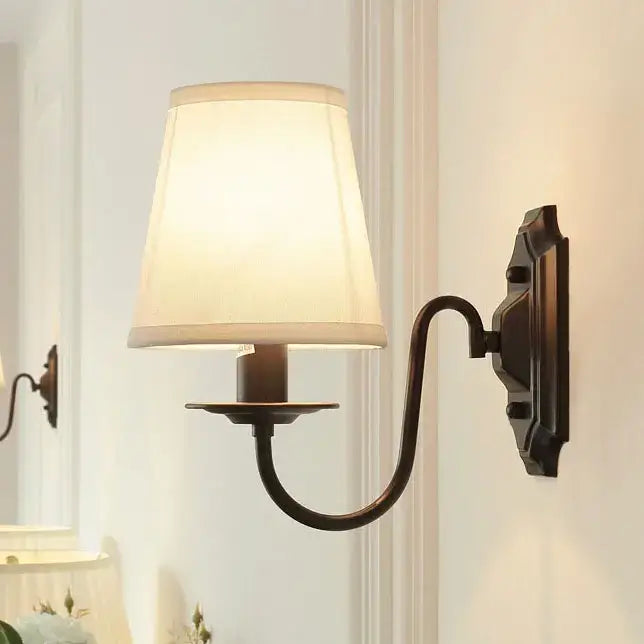 Antique bronze-finished decorbites black iron wall lamp with off-white fabric shade for living room and bedroom use