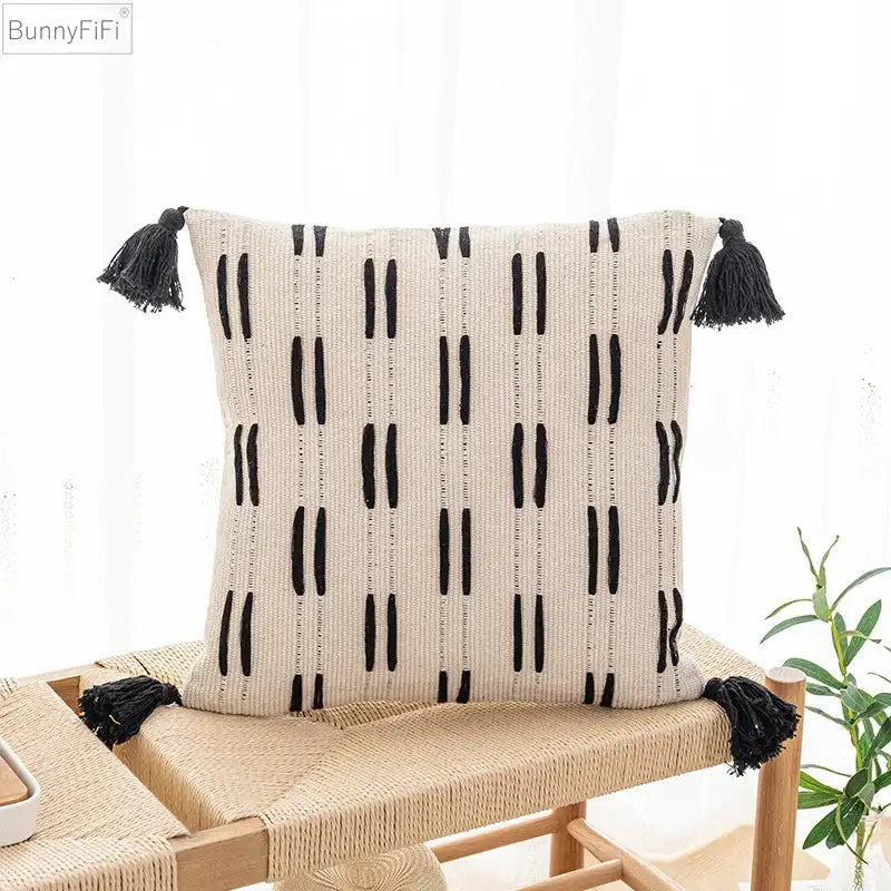 Beige woven cushion cover with black vertical tassels and embroidered stripes for living room decorbites black ivory design