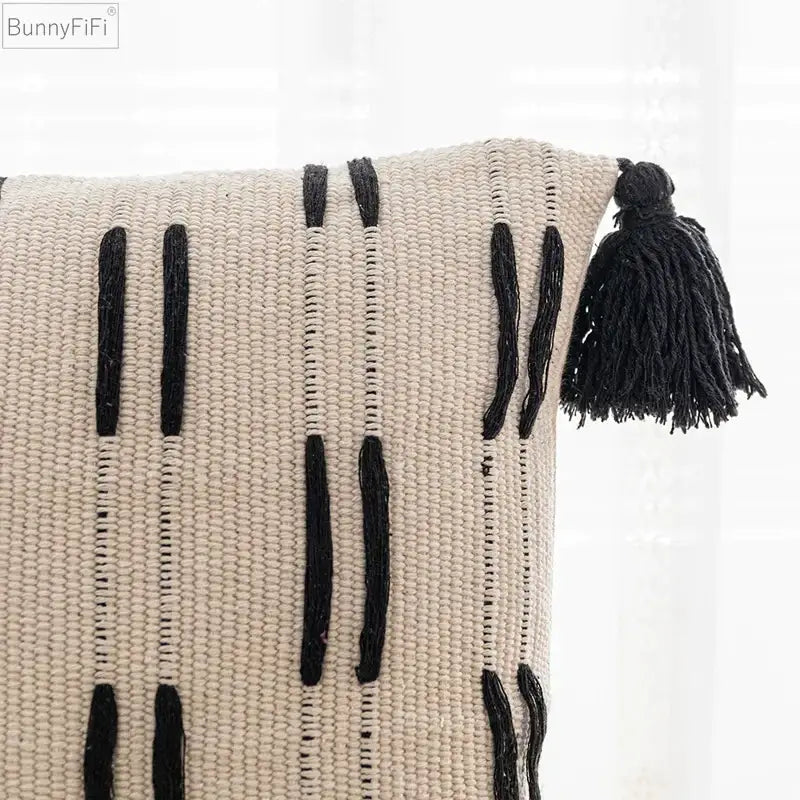 Beige woven cushion cover with black vertical tassels and decorative fringe for living room by decorbites black ivory