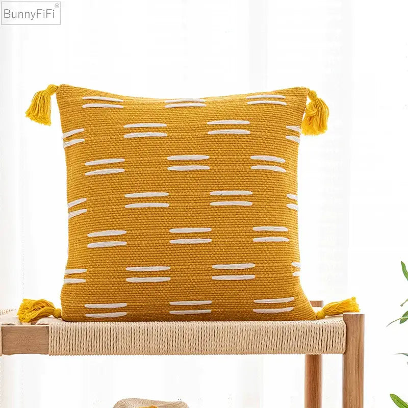 Yellow woven cushion cover with white stripes and tassels from decorbites black ivory for living room decor