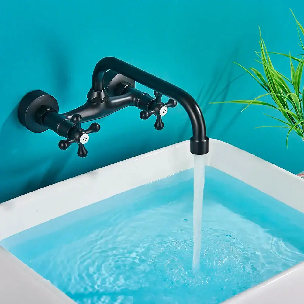 Decorbites black kitchen faucet mixer tap with black matte finish, cross handles, and curved swivel spout above white sink