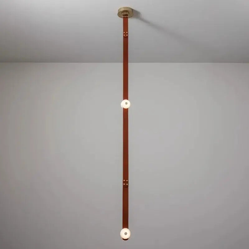 Minimalist decorbites black leather pendant light with vertical strap, white glass bulbs, and brass hardware for dining rooms