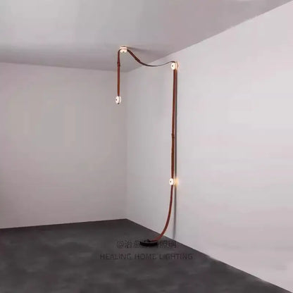 A copper-toned leather-wrapped led wall sconce with minimalist design by decorbites black leather marble chandeliers