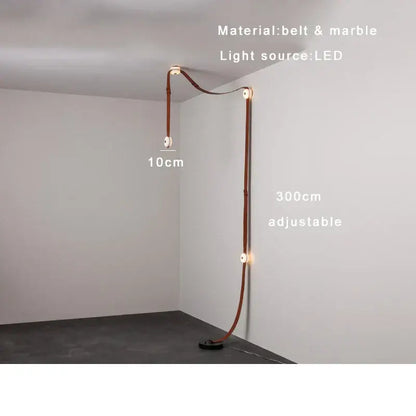 A sleek DecorBites black leather marble adjustable floor lamp with curved leather belt and marble accents for dining rooms