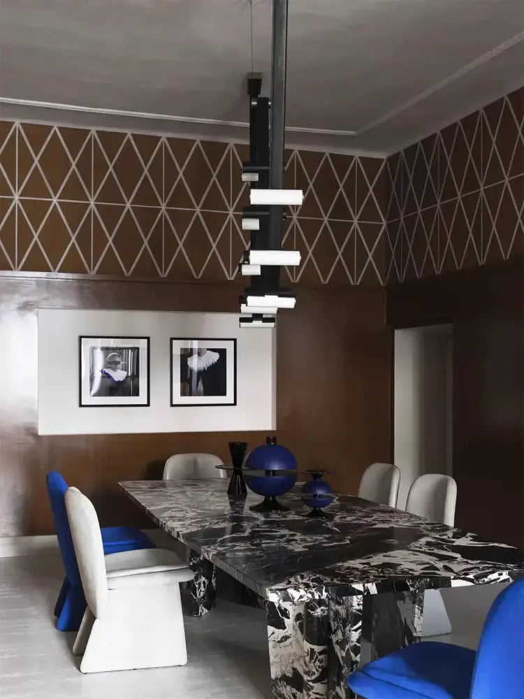 Decorbites black leather pendant light above black and white marble dining table with sleek modern legs for dining room
