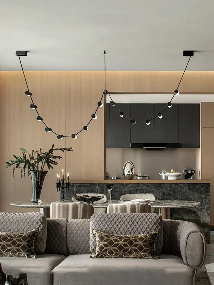 Modern black leather pendant light by DecorBites featuring spherical bulbs and minimalist design for dining room decor