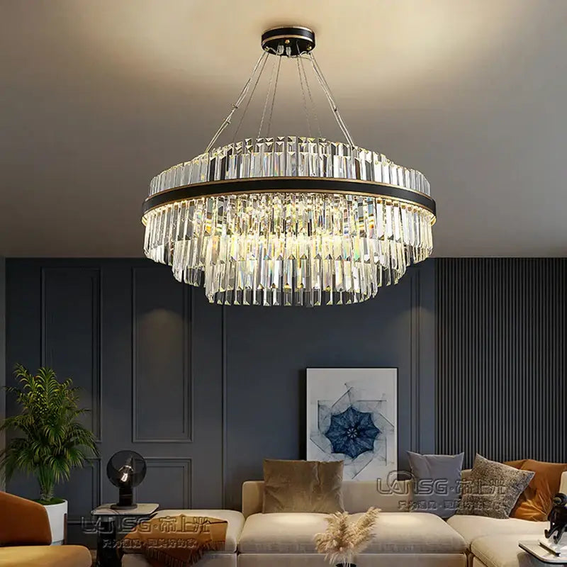 A modern decorbites black led crystal chandelier with black and gold frame and cascading faceted crystals for luxury dining