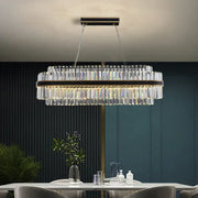 A modern decorbites black led crystal chandelier with clear prisms and dark bronze frame for luxury dining rooms