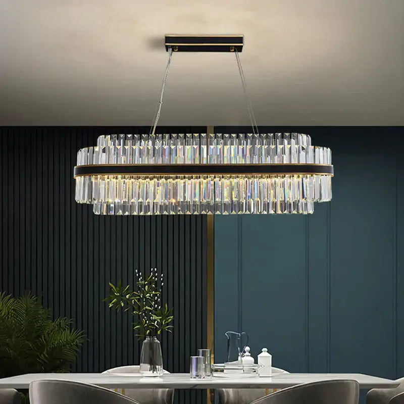 A modern decorbites black led crystal chandelier with clear prisms and dark bronze frame for luxury dining rooms