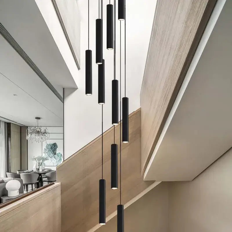Modern black led crystal staircase chandelier by decorbites featuring cylindrical pendant lights in a minimalist design