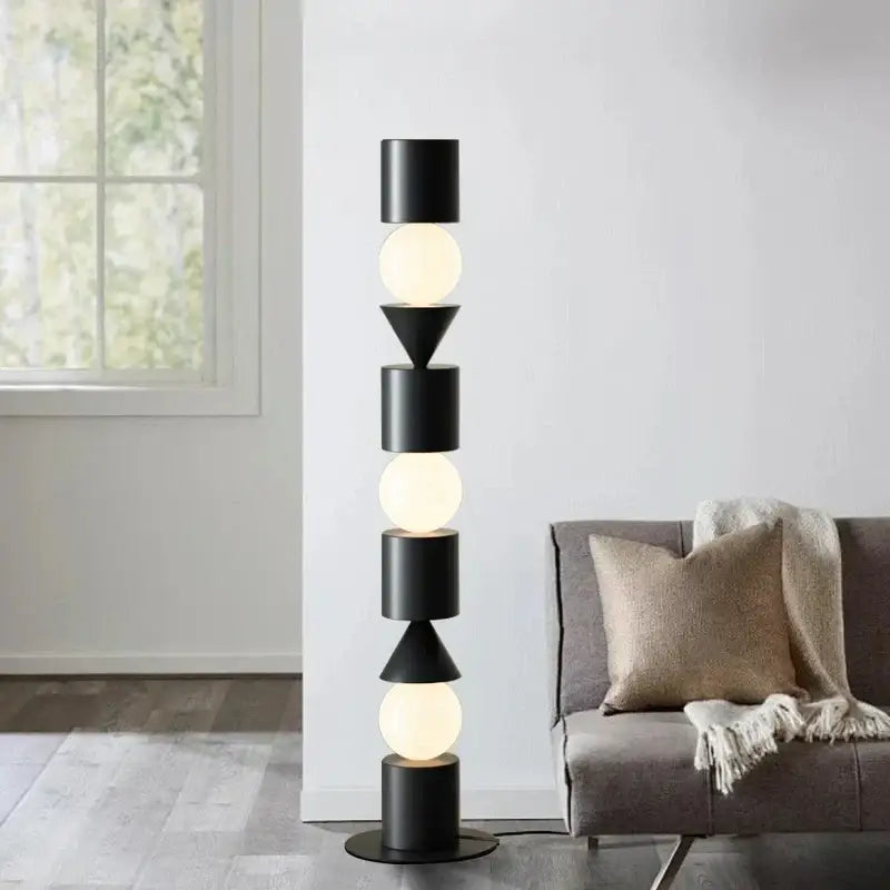 Decorbites black led floor lamp featuring black geometric matte cylindrical and triangular shades with warm glowing bulbs