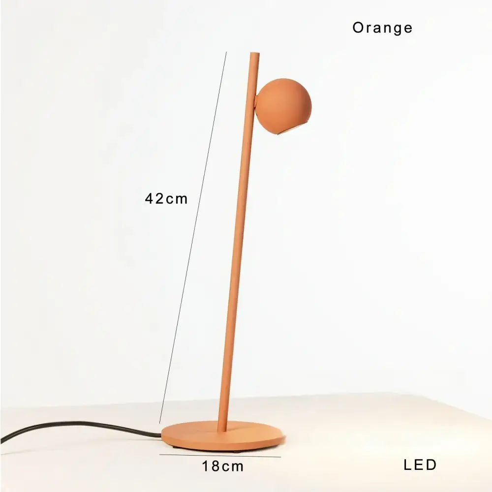Orange led desk lamp with slender matte pole and spherical head complements decorbites black led floor lamp design