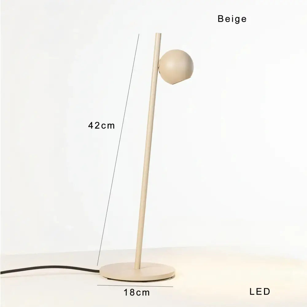 Beige led table lamp with slender cylindrical stem and spherical head complementing decorbites black led floor lamp design