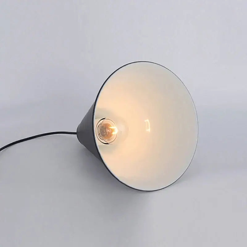 A sleek decorbites black led pendant chandelier with black and cream conical shade and visible filament bulb