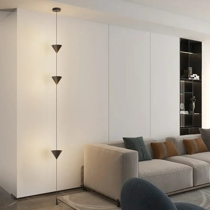 Modern minimalist black led pendant chandelier with three stacked triangular shades suspended by thin cables for Nordic decor