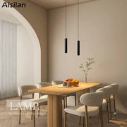 Two sleek black decorbites black led pendant lights hang from the ceiling featuring double anti-glare spot design