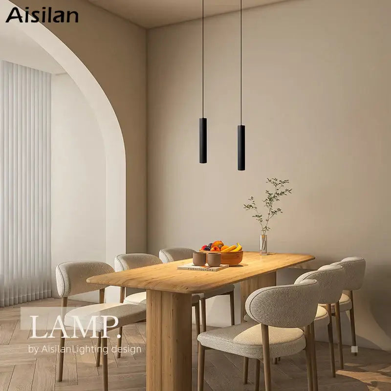Two sleek black decorbites black led pendant lights hang from the ceiling featuring double anti-glare spot design