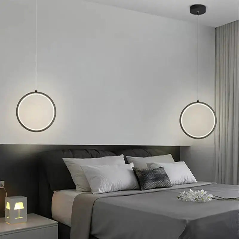 Modern circular decorbites black led pendant light with sleek black frame and glowing white led ring for elegant bedrooms